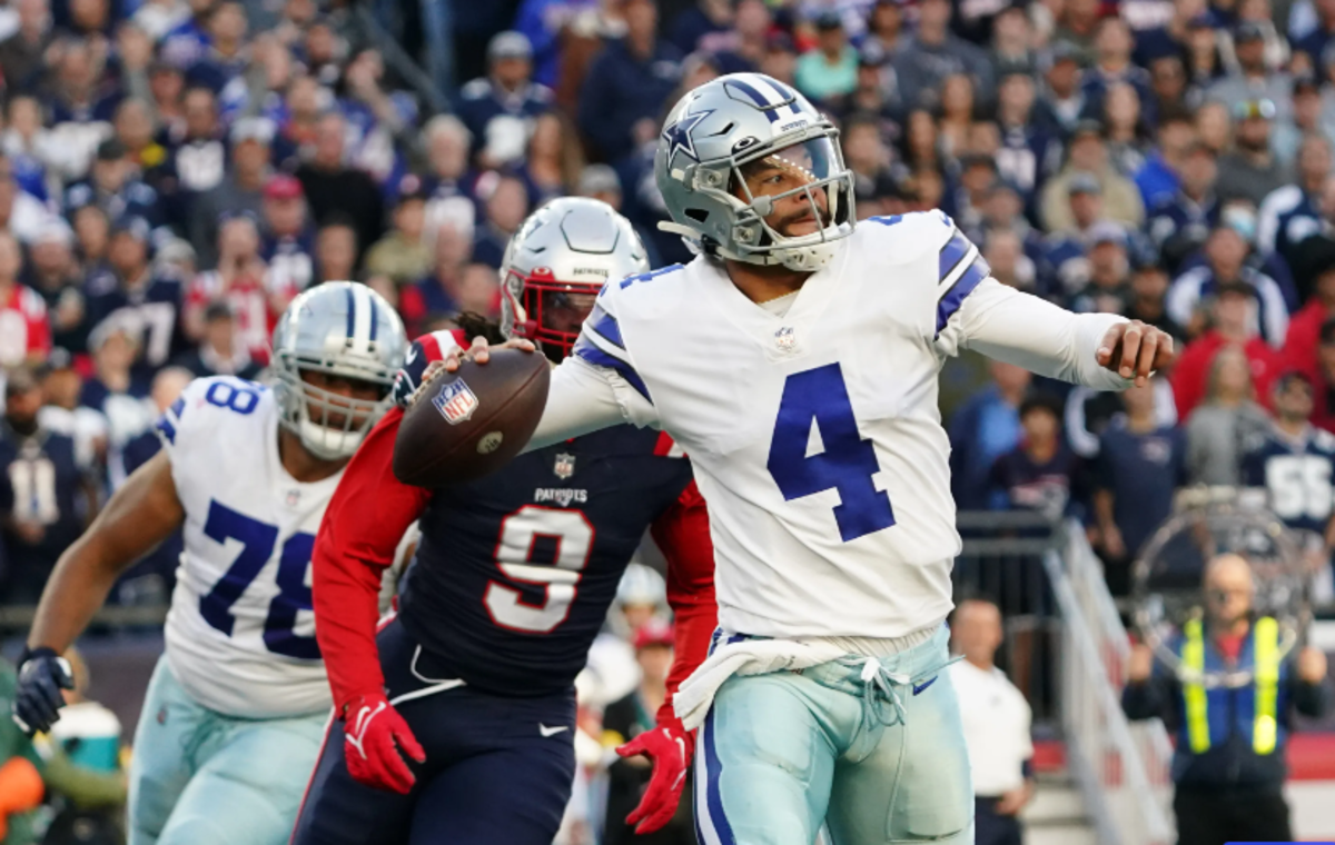 Cowboys quarterback Dak Prescott (4) is chased by Patriots defender Matthew Judon (9) during the team's last meeting in 2021
